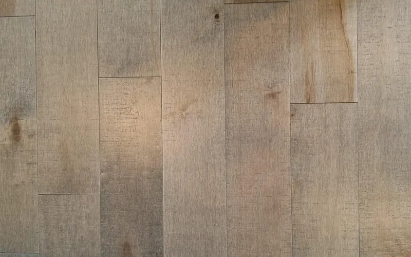 Close-up of finished maple hardwood floor boards with natural color variation Close-up of finished maple hardwood floor boards with natural color variation