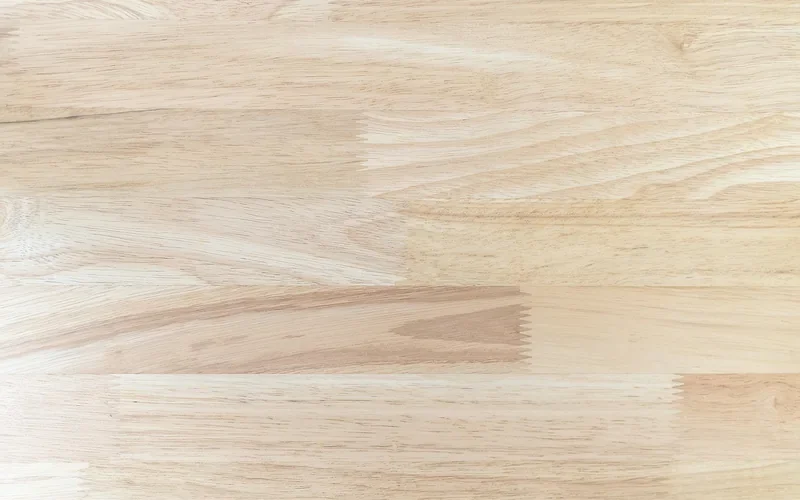 unfinished pine panel with visibly lighter and darker grain bands before staining