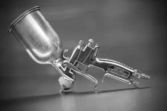 Close-up of a gravity-feed HVLP spray gun cup and air cap
