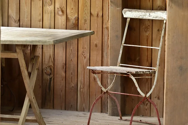 Weathered gray wood outdoor table showing natural graying from sun and weather exposure