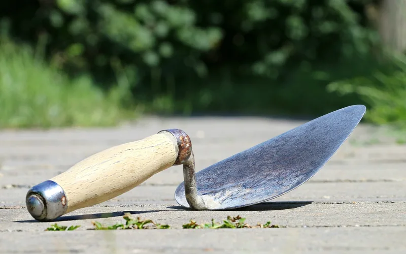 Applying Gorilla wood filler with a putty knife Applying wood filler to a wood surface with a putty knife