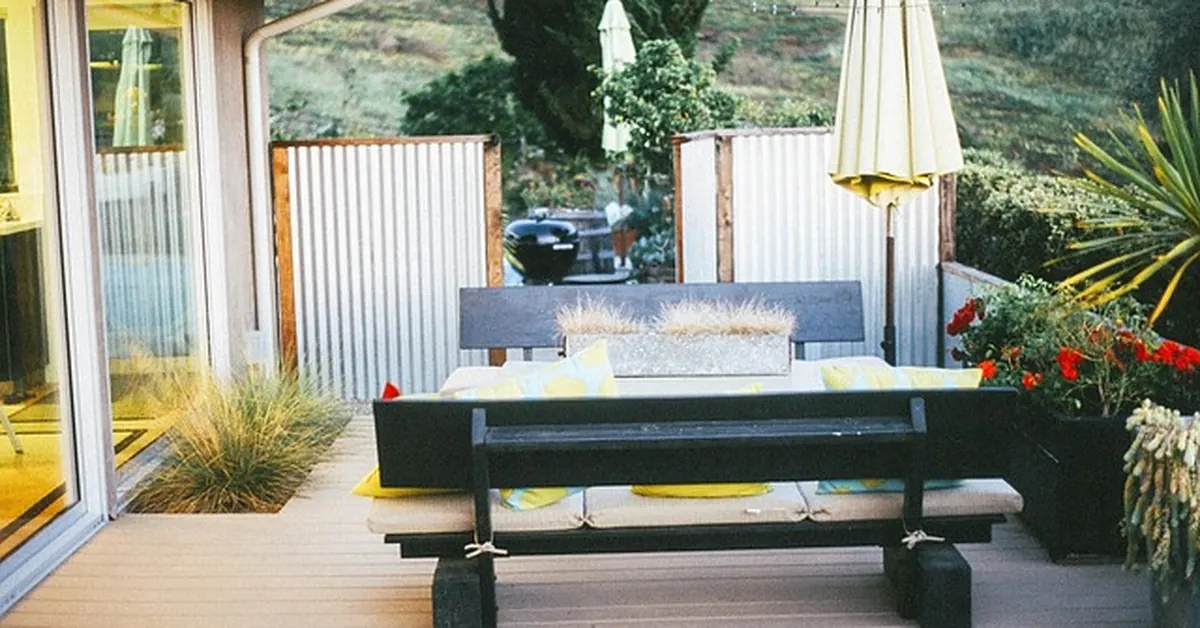 Backyard wood deck with built-in bench seating, the size and features that drive deck cost