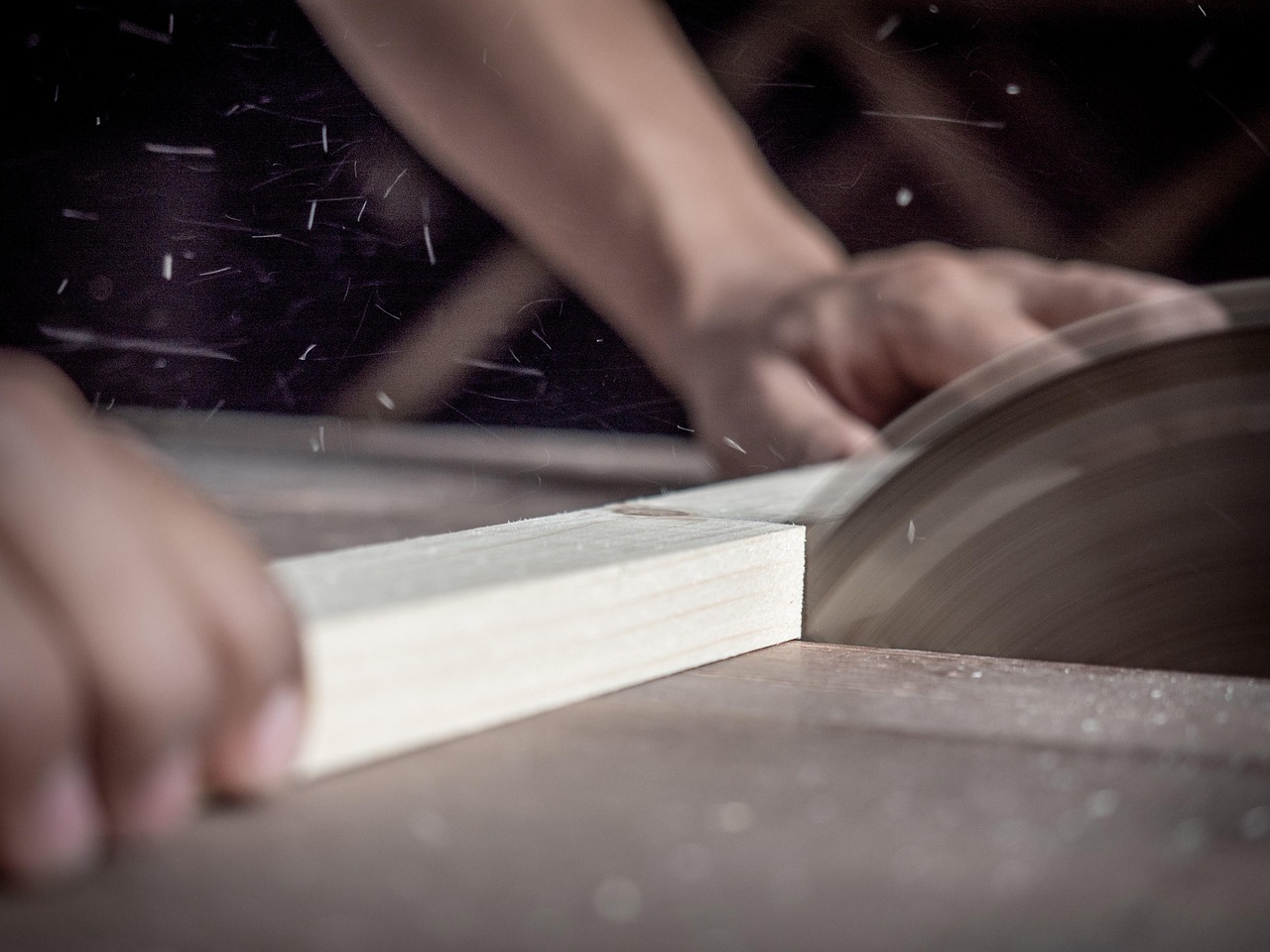 How to cut baseboard corners — carpenter at work Carpenter cutting baseboard wood with saw