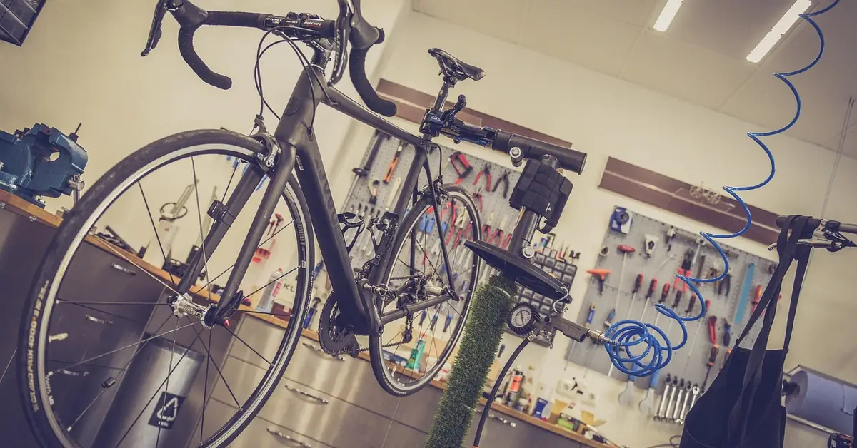 road bike lifted on a shop repair stand for drivetrain service