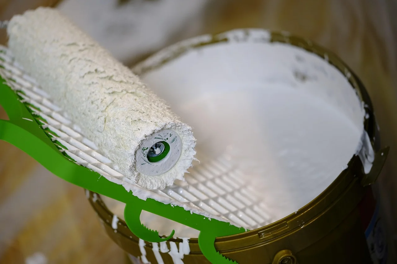 foam roller resting on an open can of bonding primer before priming a fiberglass door