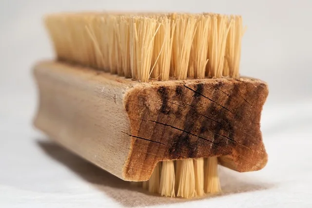 Scrub brush used to clean mildew off wood surface with vinegar solution
