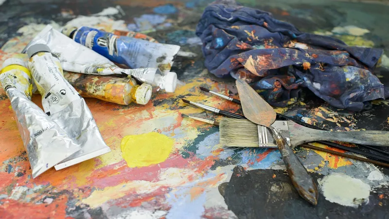 Lacquer and polyurethane application tools including spray gun, brush, sanding pad, gloves, and wood samples