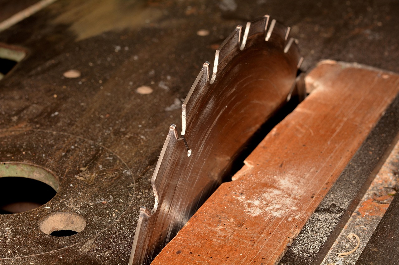 Miter saw cutting baseboard at 45 degree angle Miter saw blade cutting baseboard at angle