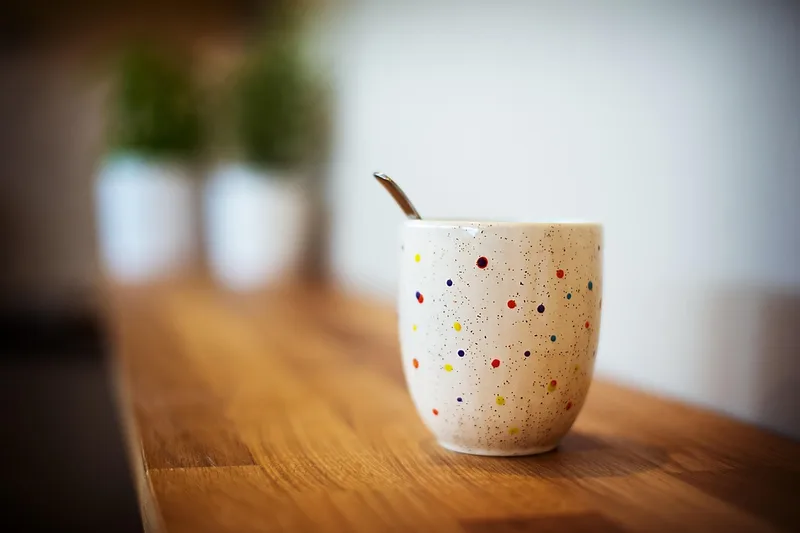 coffee mug on wood table showing how water rings form on wood surfaces