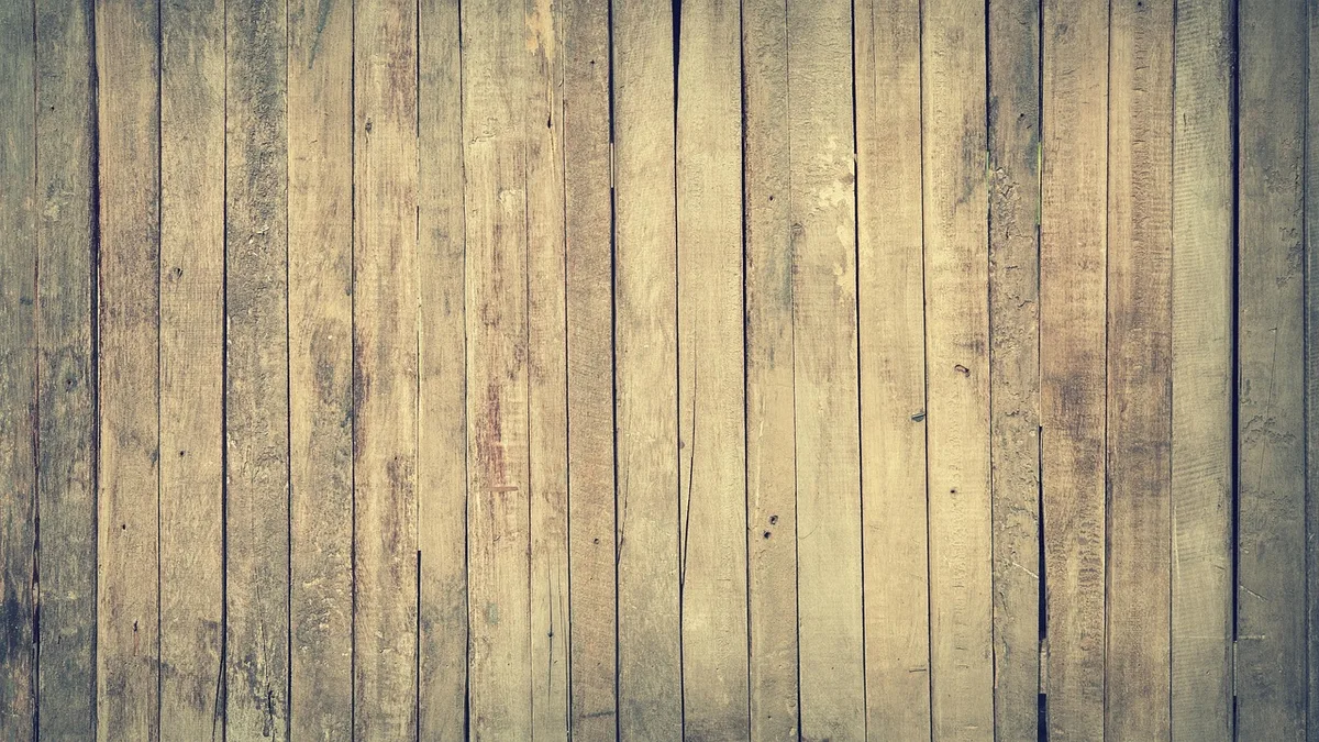 Tung oil being wiped onto a walnut board with a cloth