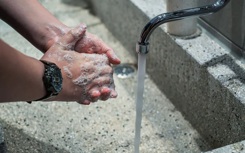 Washing paint off hands with soap and water