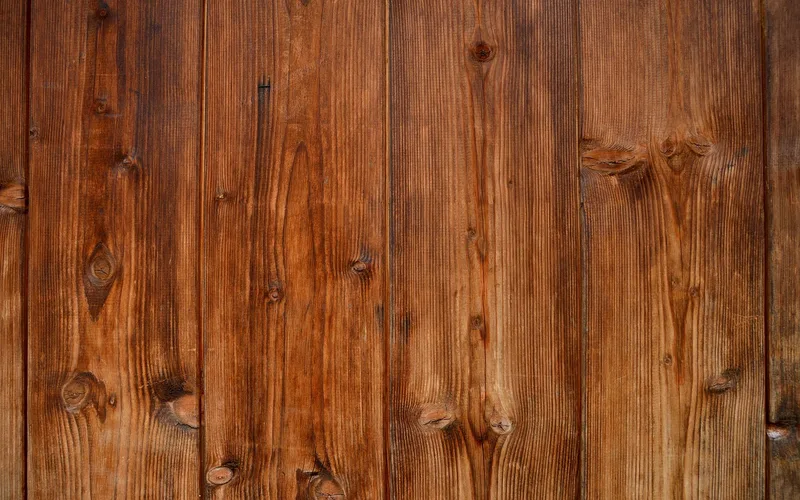 Weathered wood grain surface showing moisture after washing