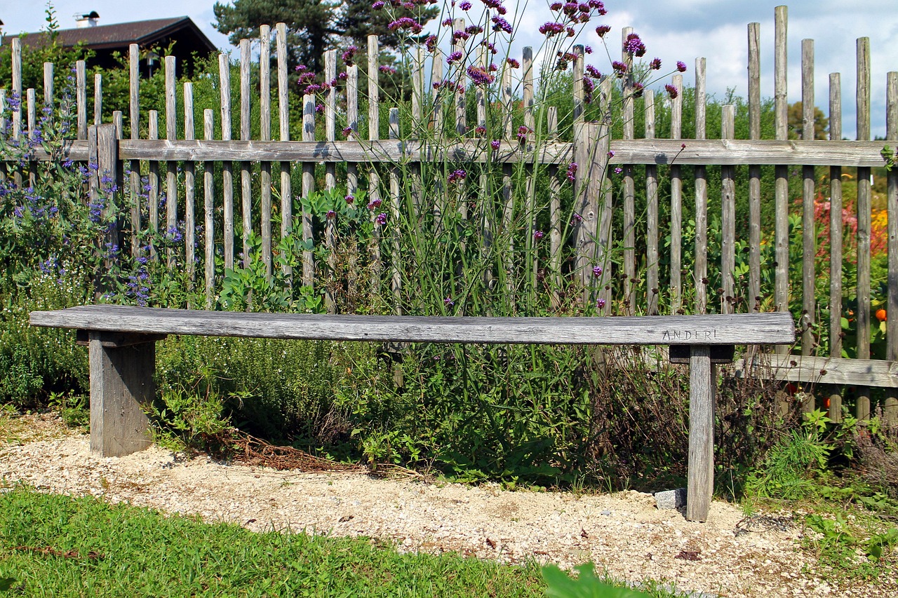 well-maintained wooden cedar fence in a garden showing longevity after staining
