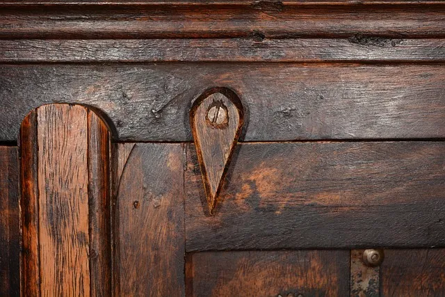 Close-up of an antique wood cabinet finish showing wear that wood restorer products target