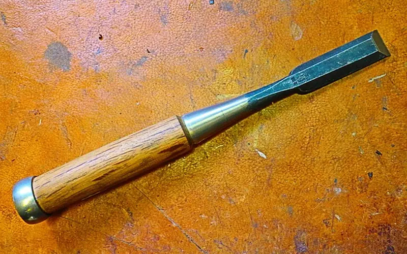 Sharp bevel-edge chisel used for paring dovetail joint pins and tails by hand