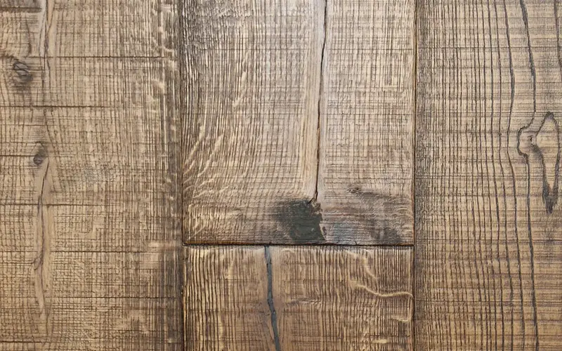 Close-up of dark oak plank flooring showing rich brown grain and plank seams