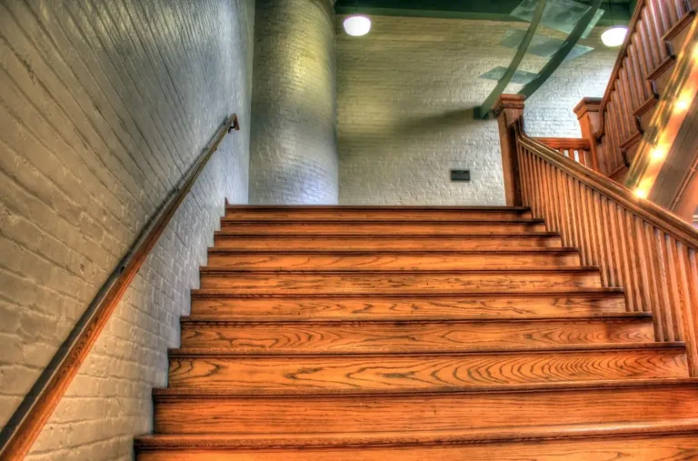 Interior wood stain finish on an oak staircase and railing with a warm amber tone