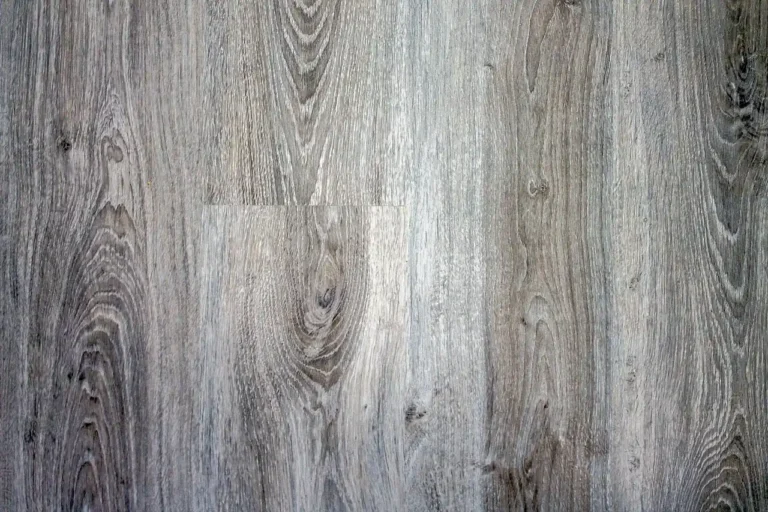 Close-up of a laminate wood finish showing its printed grain texture and repeating pattern