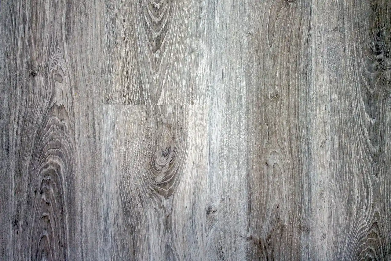 Close-up of a laminate wood finish showing its printed grain texture and repeating pattern