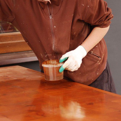 Applying wood conditioner before staining a wood tabletop