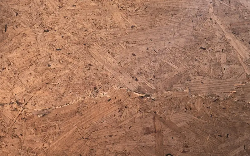 Oriented strand board (OSB) surface showing compressed wood strands Oriented strand board (OSB) surface showing compressed wood strands