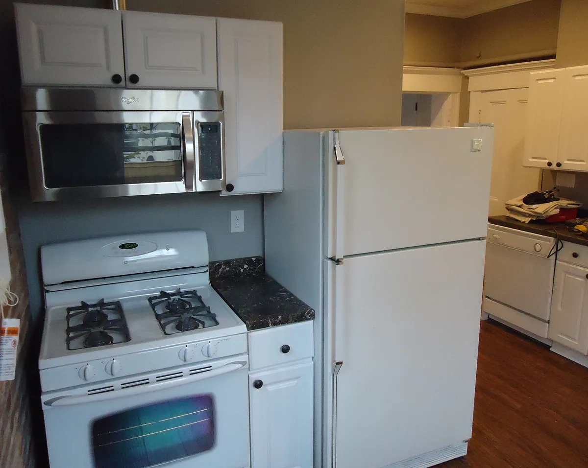 Satin-finish painted kitchen cabinets after a full cabinet repaint