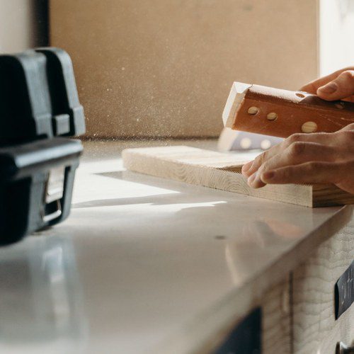 Sanding a wood block smooth before applying grain filler