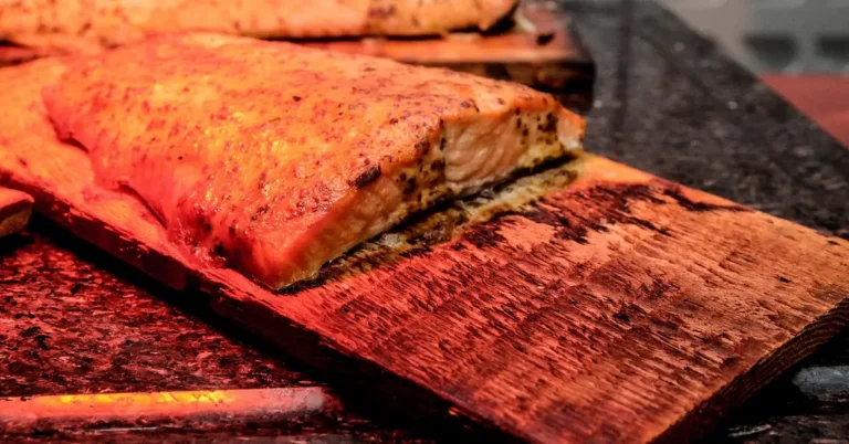 Salmon fillet grilled on a cedar plank with charred smoky edges