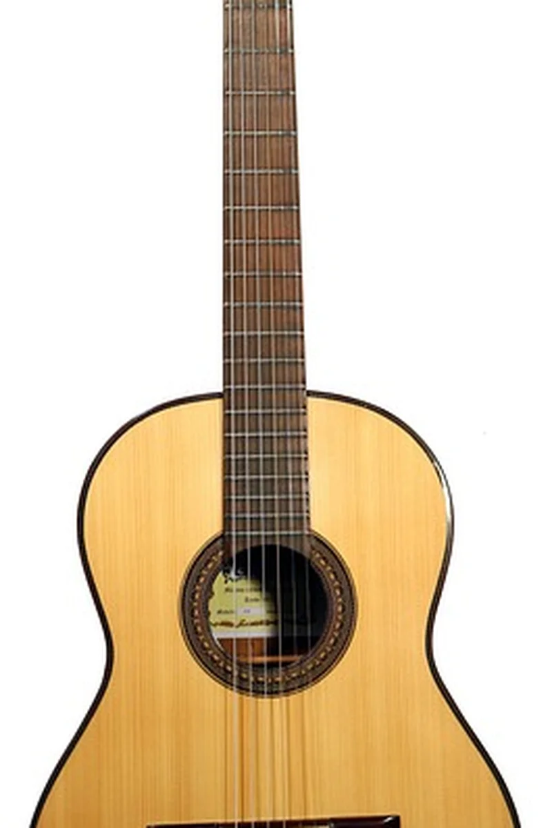 Finished classical guitar neck and body showing the curved outline a band saw cuts Finished classical guitar neck and body showing the curved outline a band saw cuts