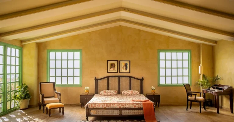 Bedroom with dark wood furniture: cane bed frame, matching nightstands, and armchairs