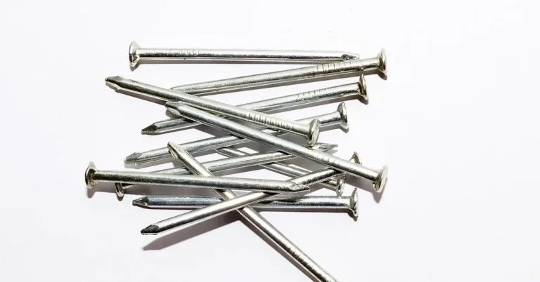 A pile of finish nails used for attaching baseboard trim to the wall stud