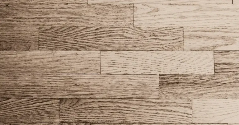 Hardwood floor planks with visible seams and cracks between boards