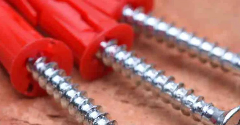 Red plastic screw inserts with matching screws for drywall and MDF