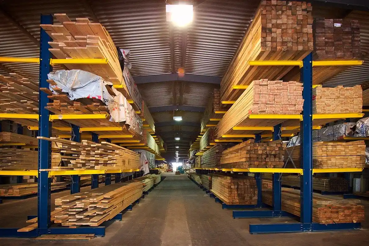 stacked lumber and sheet wood products at a timber yard warehouse