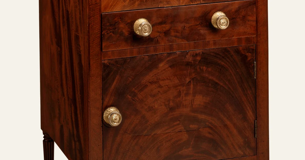 Close-up of a smooth, glossy stained mahogany cabinet showing the wood grain