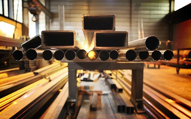 Round and square steel tube stock stacked in a metal shop, the kind of thin-wall material that needs a finer-TPI bandsaw blade Round and square steel tube stock stacked in a metal shop, the kind of thin-wall material that needs a finer-TPI bandsaw blade