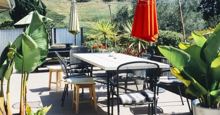 Composite deck with tan-brown boards and outdoor patio furniture