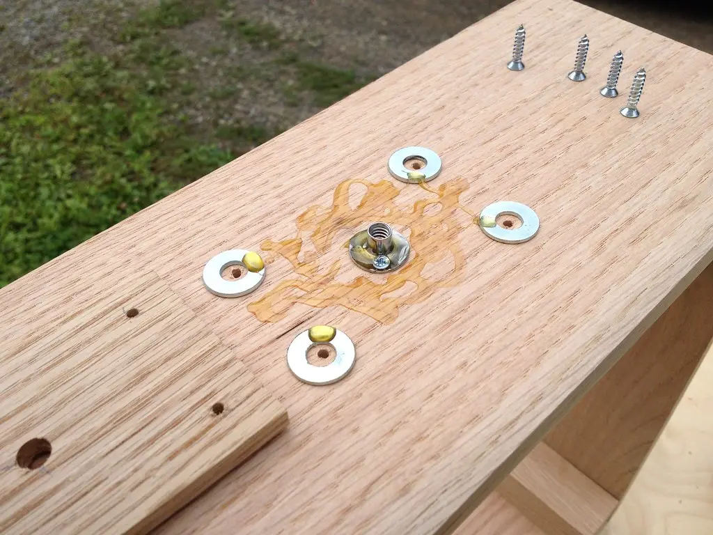 Close-up of epoxy being brushed onto a sanded teak joint
