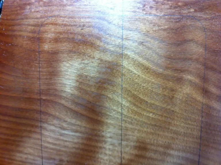 Woodworking bench with epoxy resin, mixing cups, and a live-edge wood slab in natural light