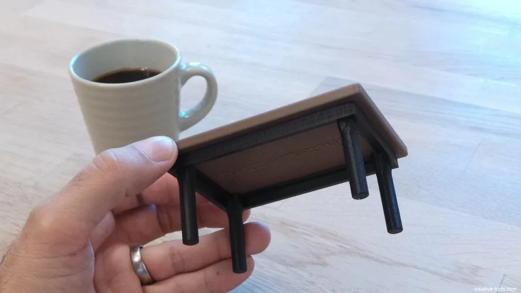 Close-up of wood glue spread along a tabletop board edge with a roller