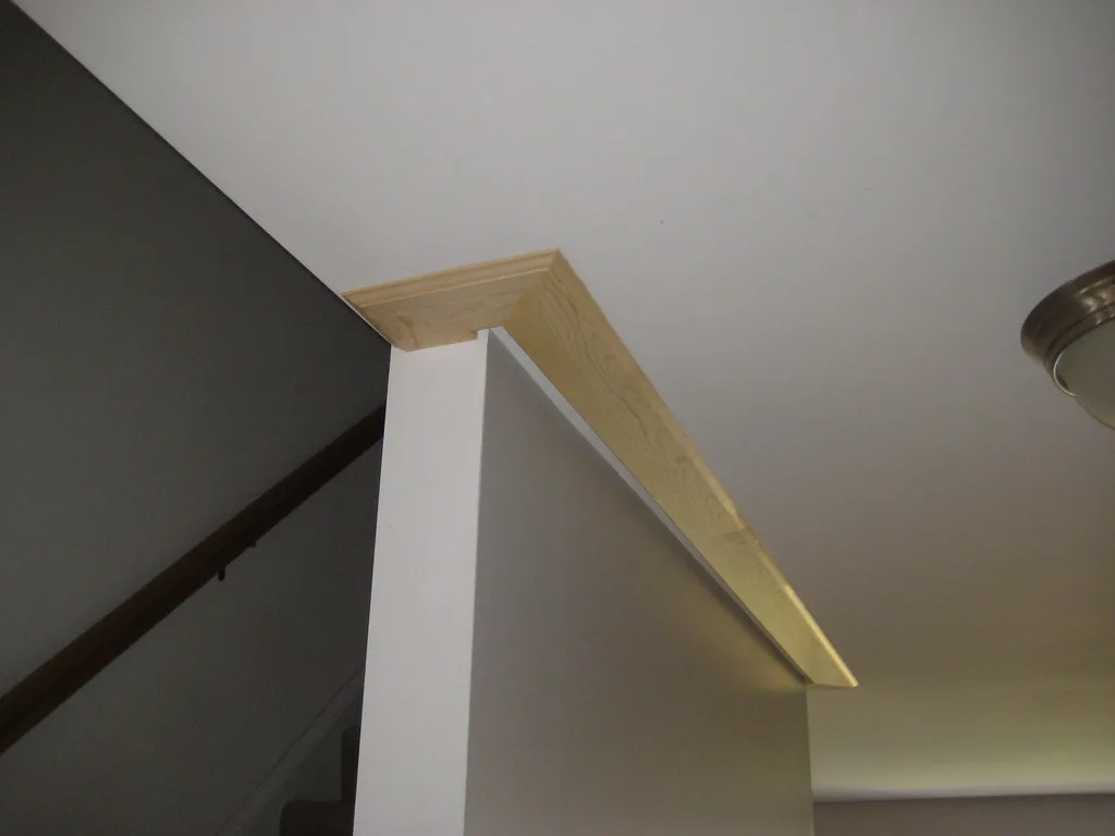 Close-up of construction adhesive on the back of crown molding before installation