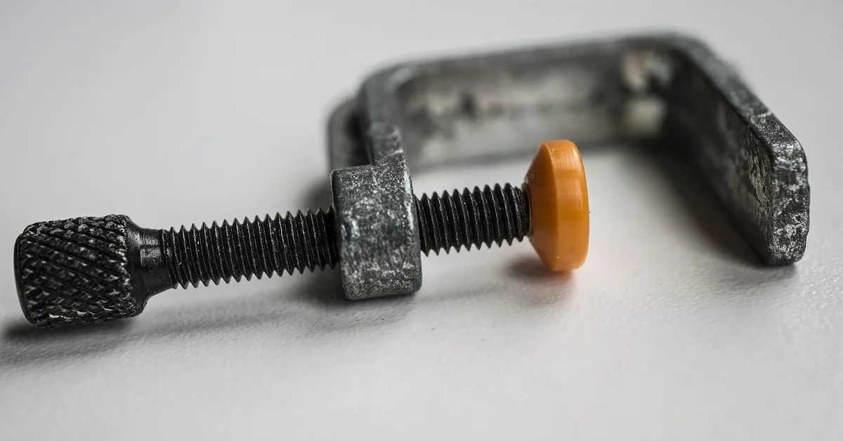 Small screw clamp used for wood glue-ups in a woodworking project