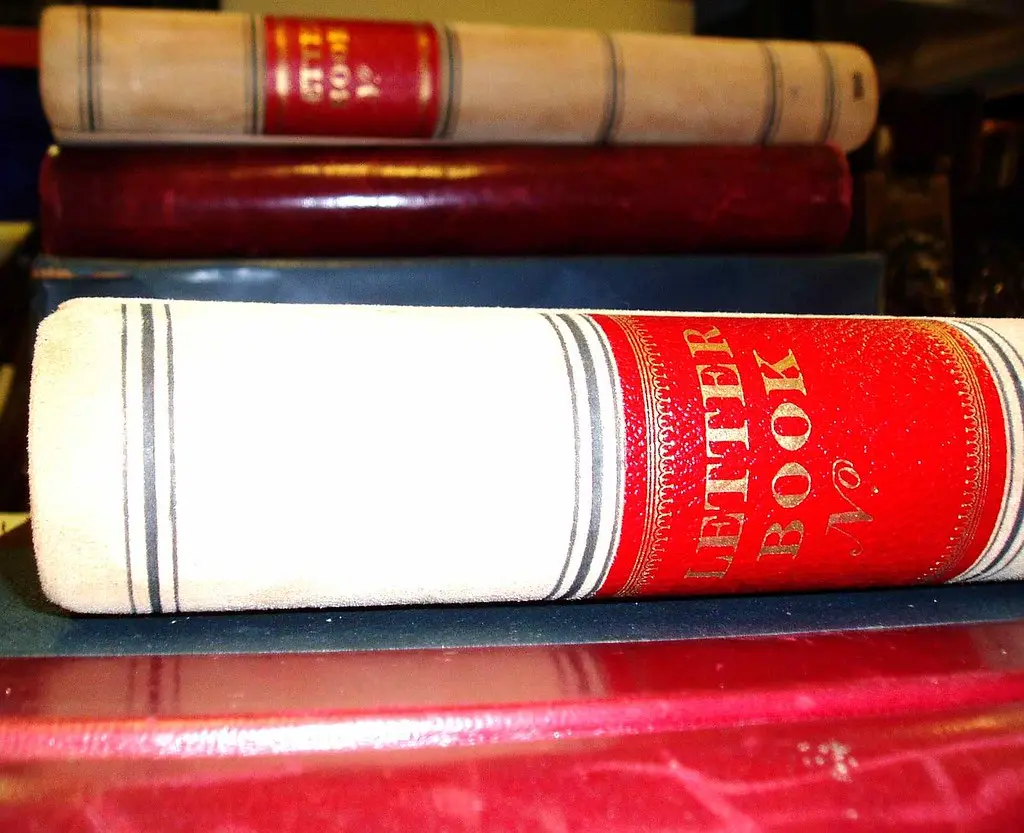 Close-up of a wood glue joint failed, showing dried glue and torn fibers as it is pried open.