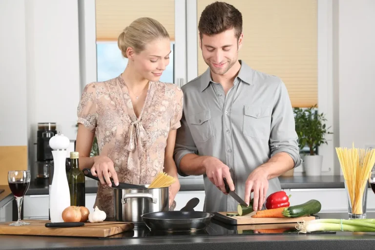 Wooden cutting board with food-safe oil, cloth, and vegetables in natural light