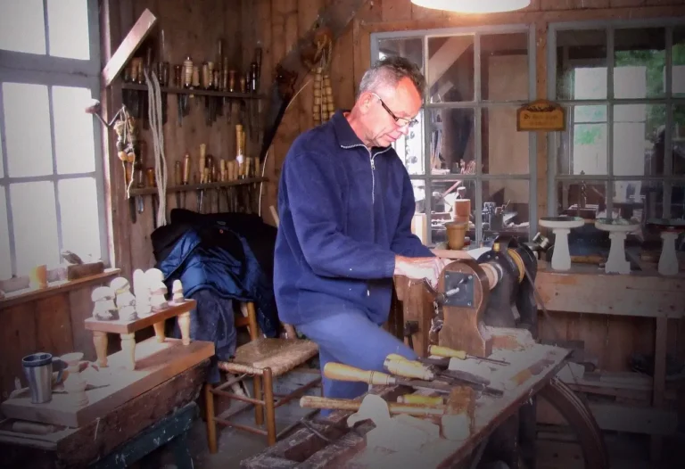 Beginner woodworker comparing a DIY workbench in a small garage shop