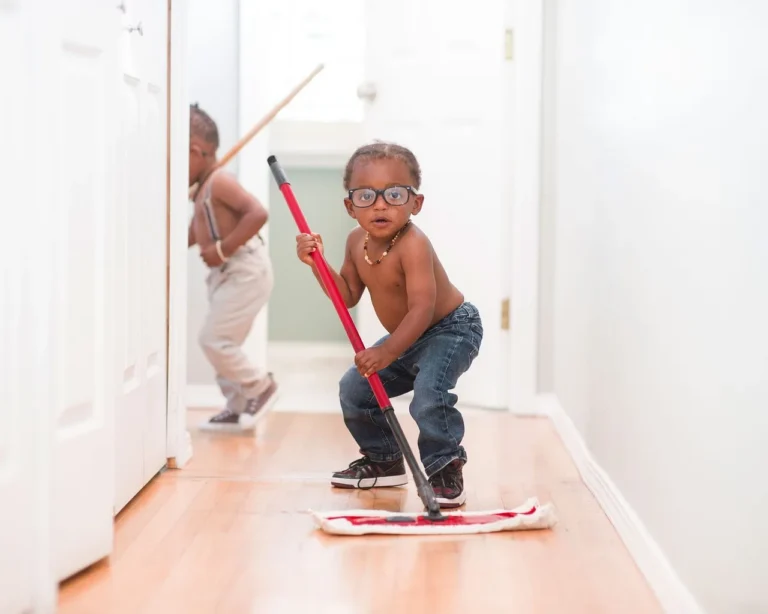 A person mopping a hardwood floor with a microfiber flat mop in a bright living room