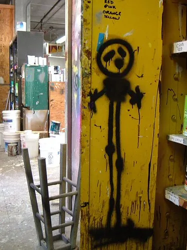 Close-up of a paint sprayer laying an even finish on a cabinet door