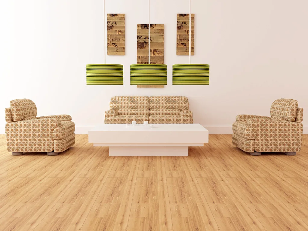 Person comparing floor care products on a bamboo floor in a sunlit living room