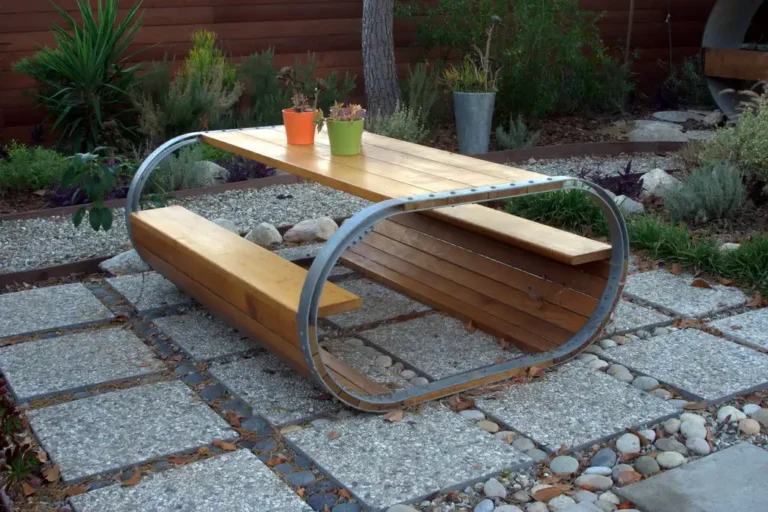 Redwood outdoor furniture set on a sunny patio with table, benches, and chairs