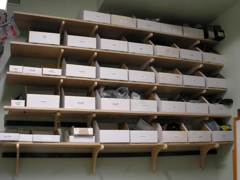 Woodworker comparing router bits beside MDF samples and a plunge router in a bright workshop.